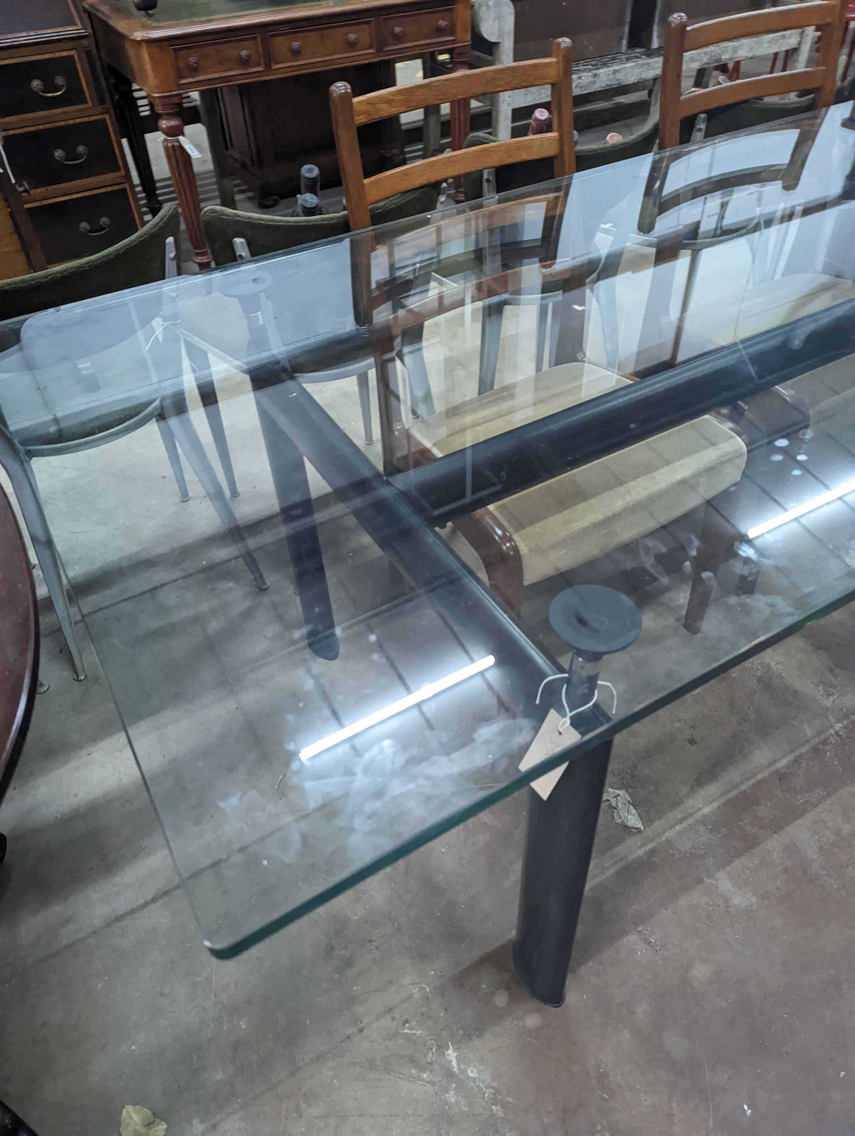 Mid century design. An LC6 style rectangular glass top dining table, length 210 cms, width 85 cms, height 74 cms.